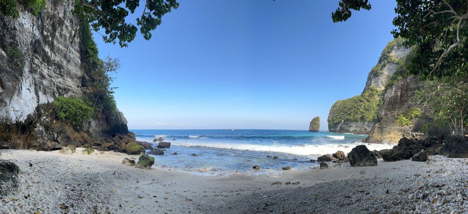 Secluded beach framed by rocky cliffs and tropical greenery